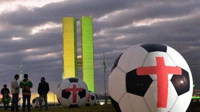 Anti-World Cup protesters inflate giant footballs in Brasilia