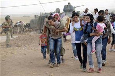 Syrian Kurds 'halt ISIL push' near Turkey