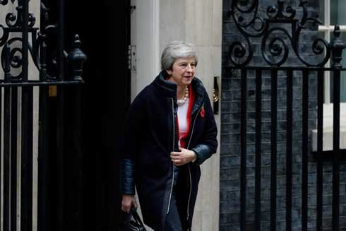 UK's May takes Brexit deal to cabinet as MPs revolt