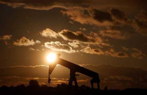 Oil falls, weighed by rising U.S. fuel stocks, crude output