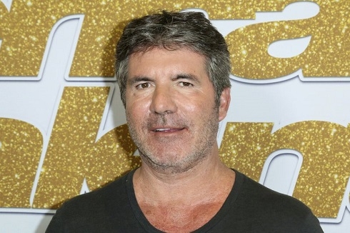 Simon Cowell has surgery for broken back after bike accident