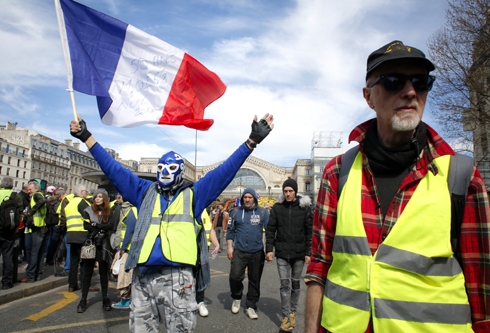 France’s yellow vest protesters march despite bans, injuries